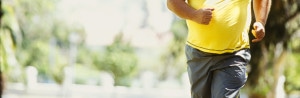 portrait of a mid adult man jogging in a park