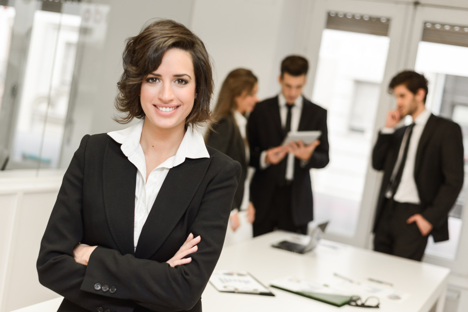 Image of businesswoman leader looking at camera in working environment