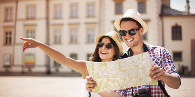 Happy tourist sightseeing city with map