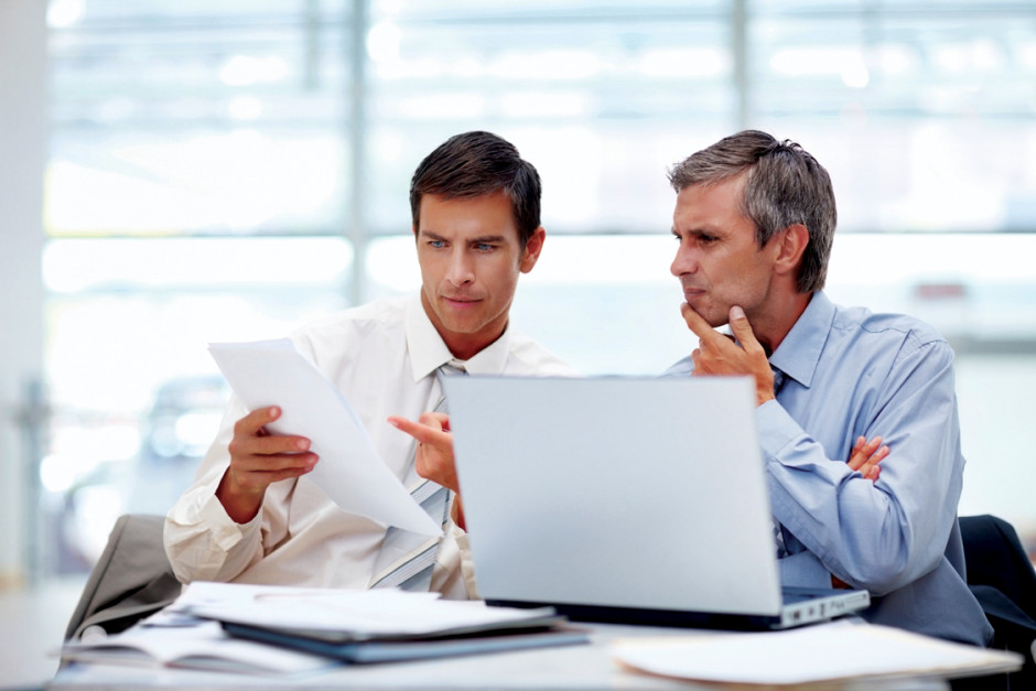 Portrait of a group of business men working together at a meeting